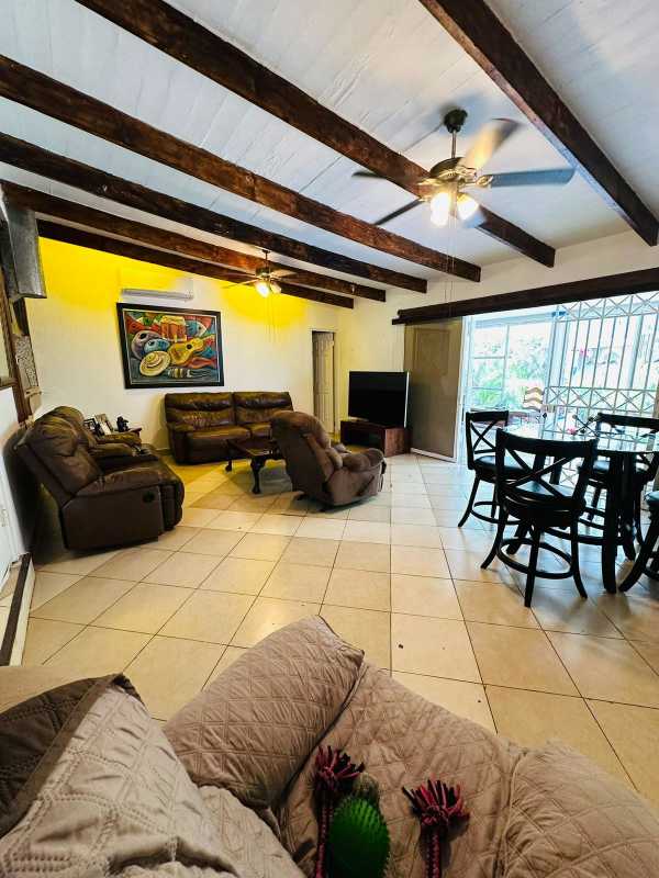 Open living dining with ceiling fans, beams, traditional elements in Balboa Panama City house
