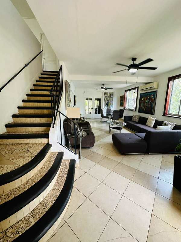 Rustic living dining room with wooden beams, tile flooring, sliding glass doors in Balboa house for sale