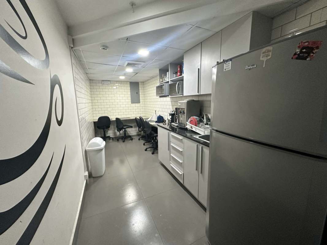 Office kitchenette with cabinetry marble countertop and large windows at Prime 507 Tower Panama