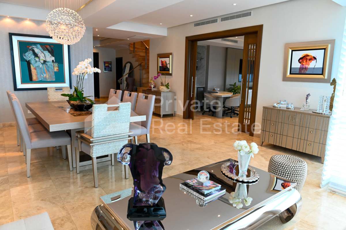 Open-concept dining and living room with marble floors, large windows in PH Titanium Costa del Este Panama