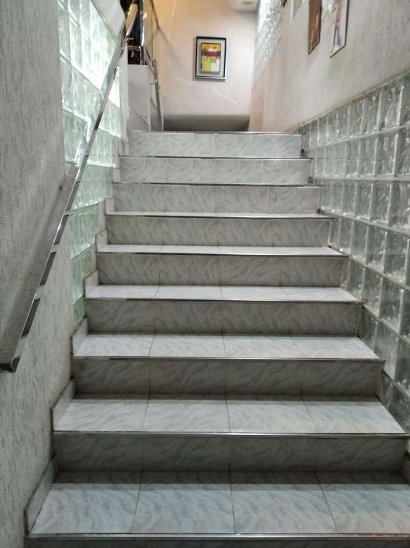 Tiled indoor stairs with glass block walls at Plaza El Carmen commercial building Panama