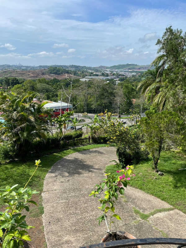Mediterranean house with stone wall exterior, balcony, terracotta roof and garden in Las Cumbres Panama