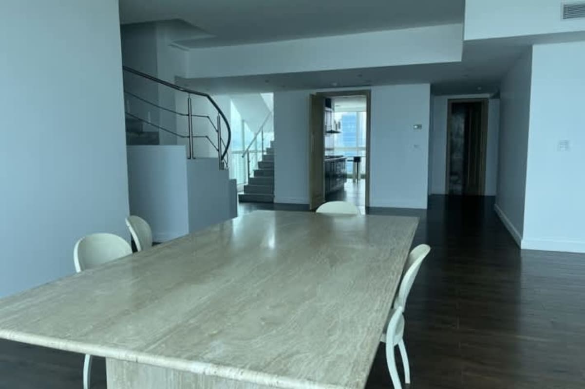 Double-height penthouse living room with panoramic windows in PH Ocean Two Costa del Este Panama