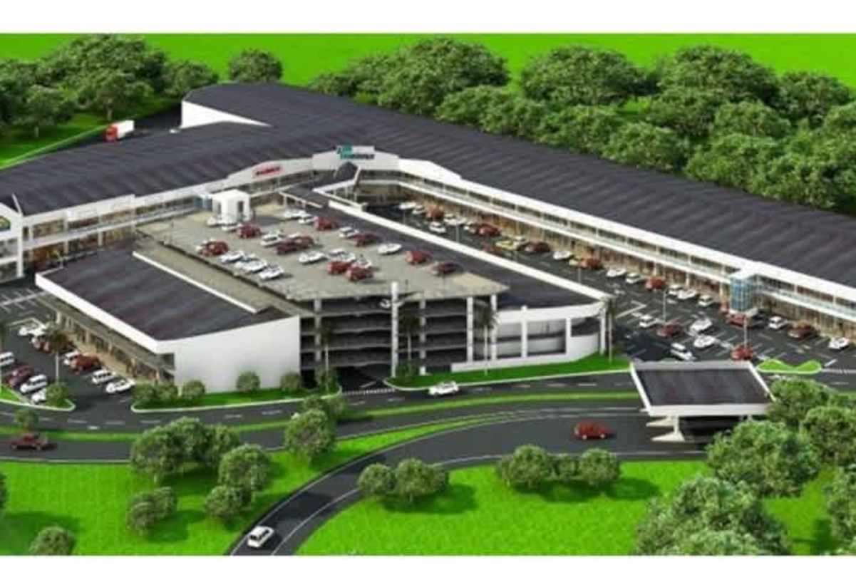 Aerial view showing Costa Sur commercial plaza with parking and surrounding landscape Panama City