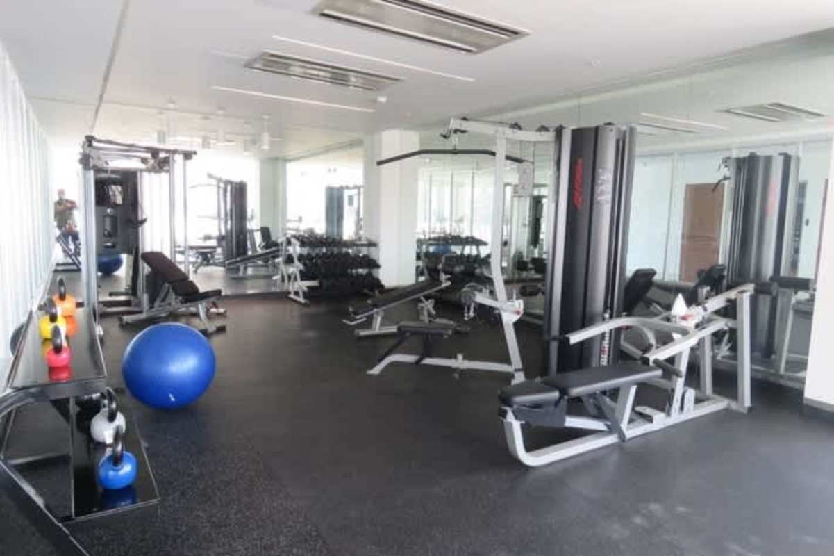 Minimalist bedroom with large window and built-in storage PH Greenwood Panama