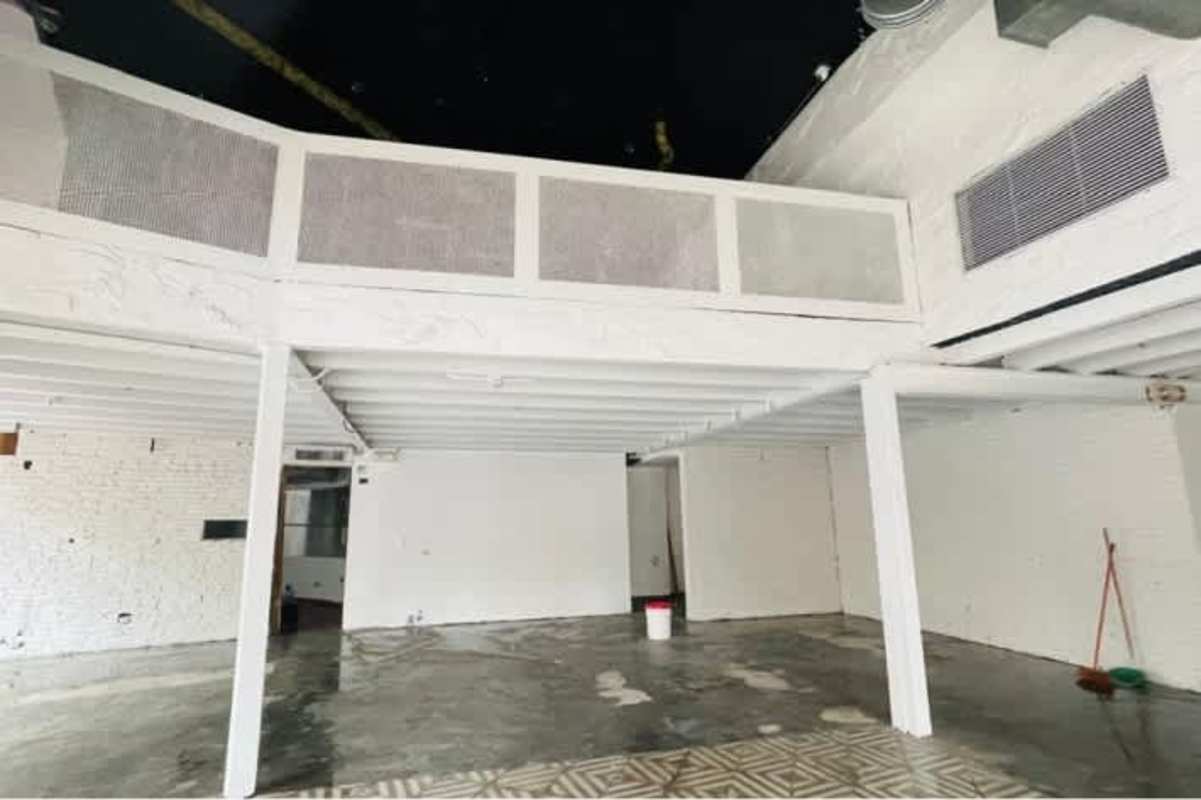 Interior view industrial loft commercial space with mezzanine exposed beams Panama City Casco