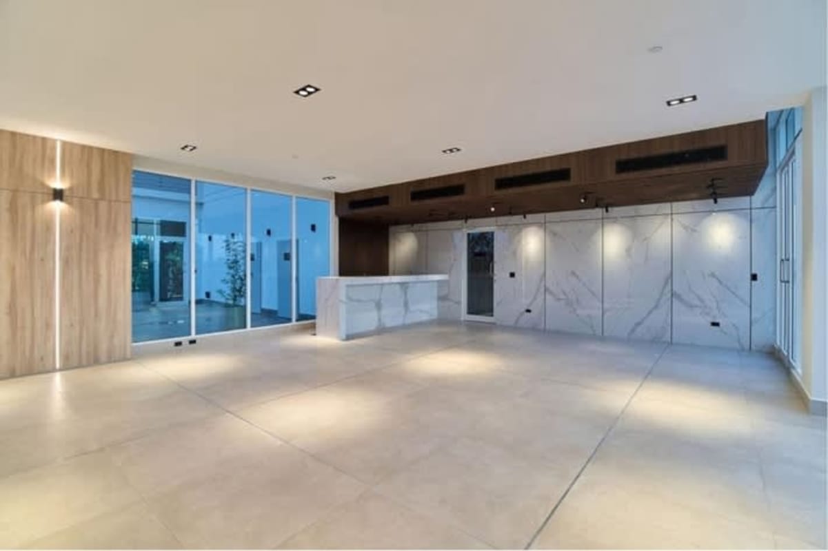 Elegant reception lobby with marble details glass doors and wood paneling PH Bonavista The Park Panama
