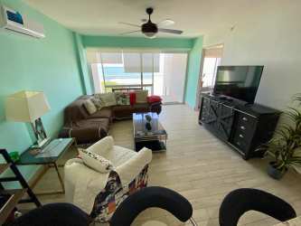 Bright open kitchen and living space with granite counter at Playa Caracol Sanctuary