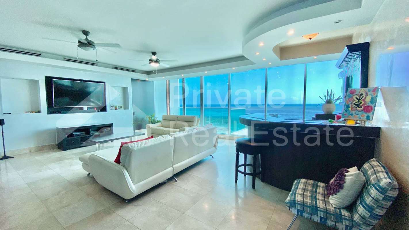 Living room with full oceanfront windows and modern decor in PH Ocean Two Costa del Este