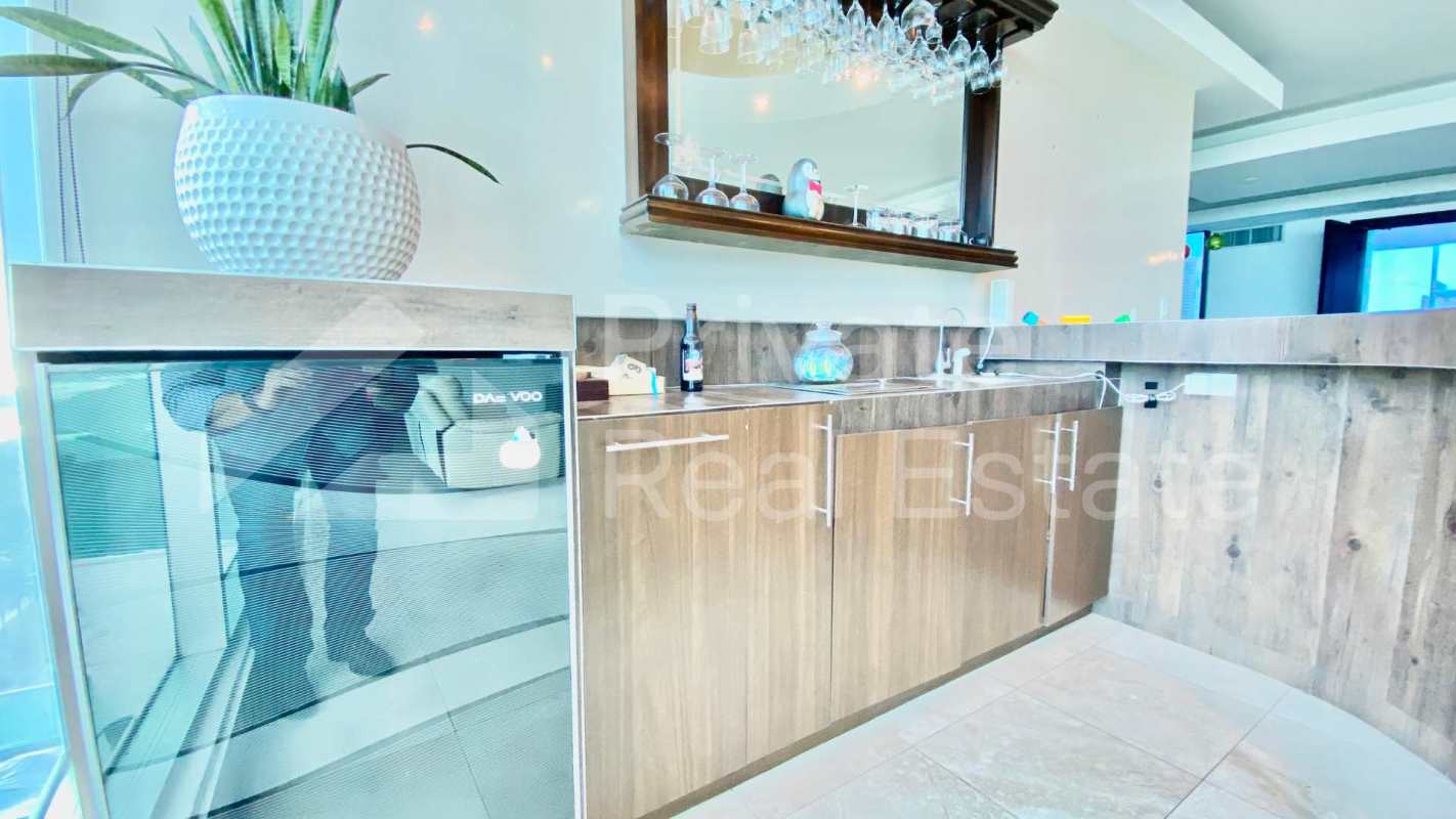 Modern built-in bar with wood cabinets mini fridge PH Ocean Two Panama City