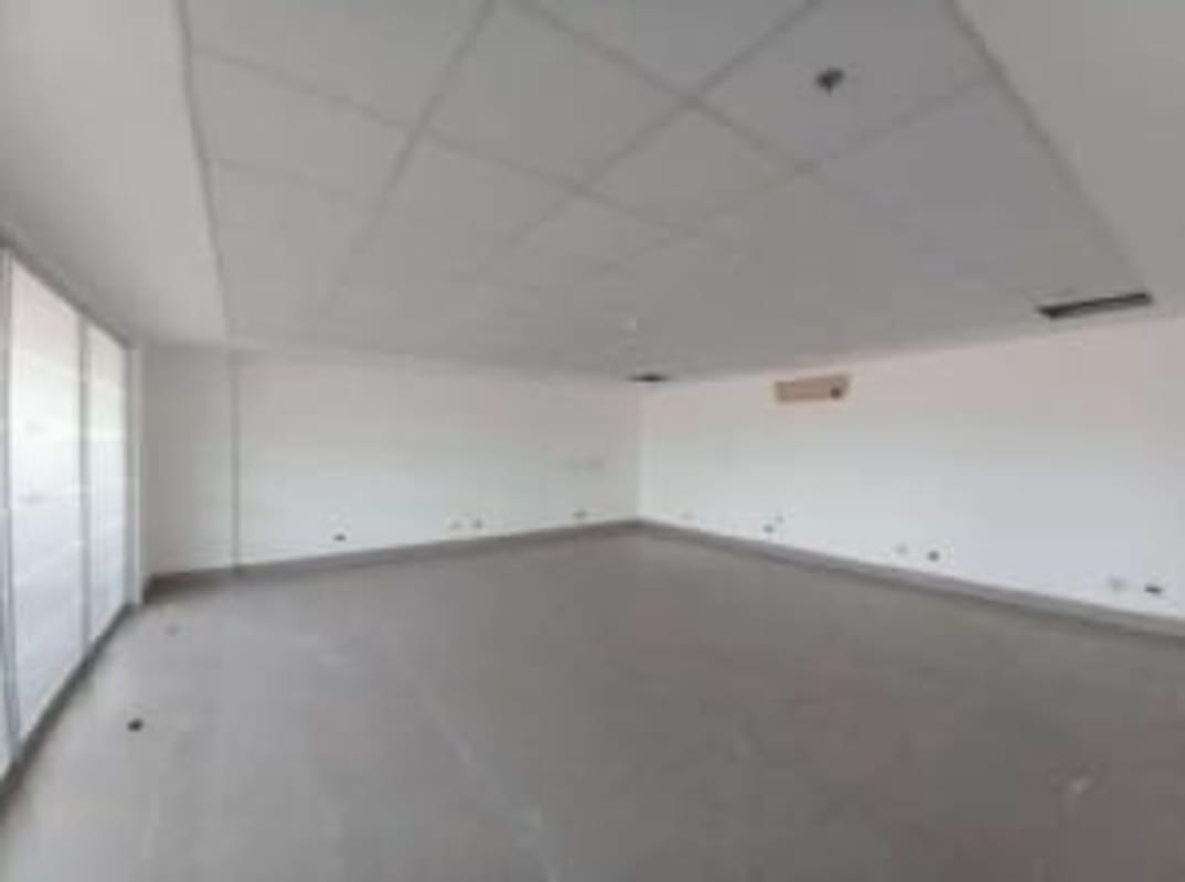 Spacious empty modern office with large windows inside warehouse Tocumen