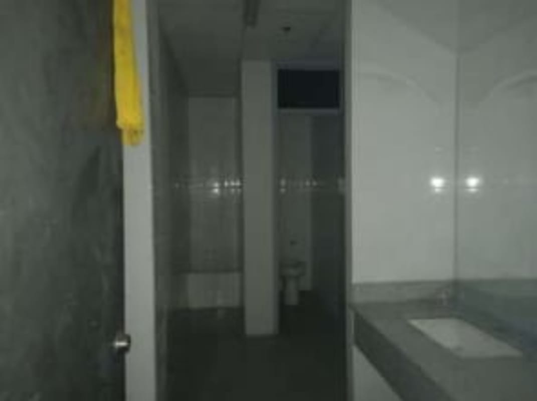 Modern commercial bathroom with gray tiles wall and toilet Villas Santa Barbara Tocumen