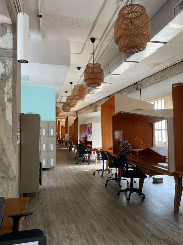 Modern industrial office interior with exposed ducts and shared desks in Casco Viejo Panama