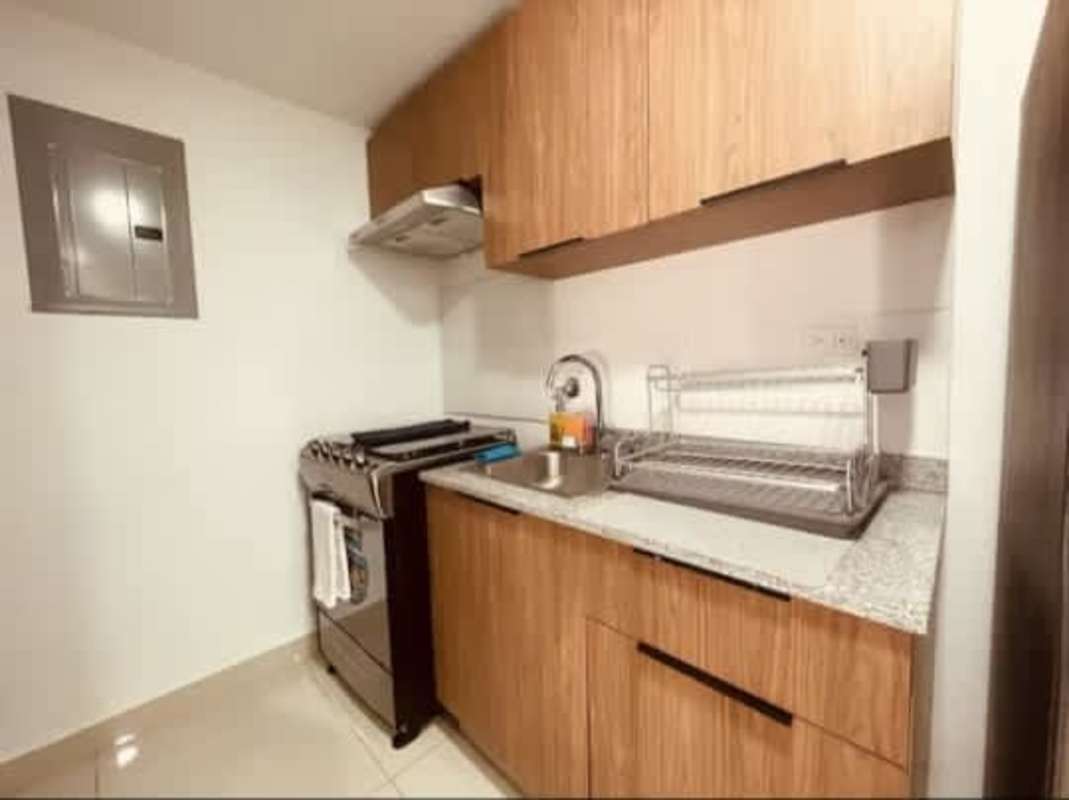 Modern apartment kitchen with granite countertops and stainless steel stove in PH Worldwide Plaza Panama