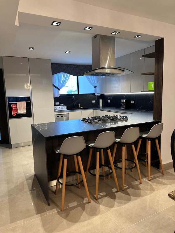 Modern open plan dining and living room with large windows and marble floors PH Country Park Panama