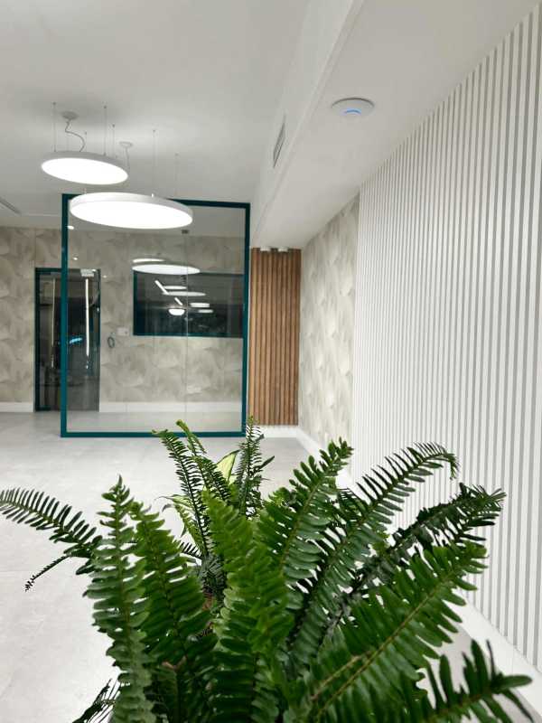 Modern conference room with wood slat walls, glass doors, and neutral decor Marbella Panama