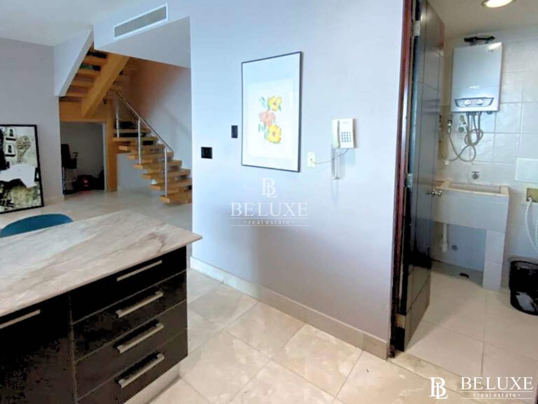 Contemporary kitchen with granite stone counters and built-in appliances at PH Pacific Village Punta Pacifica Panama