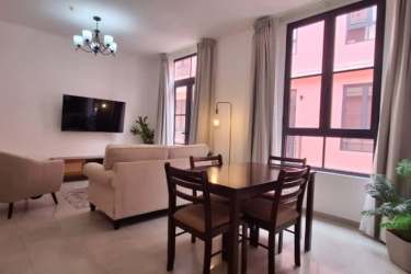 Modern white-tiled bathroom with glass shower enclosure at Casa Korsi Casco Viejo Panama City