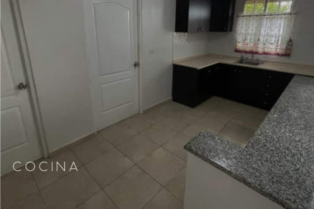 Kitchen with granite style countertop dark cabinetry tiled flooring Cerro Viento Panama