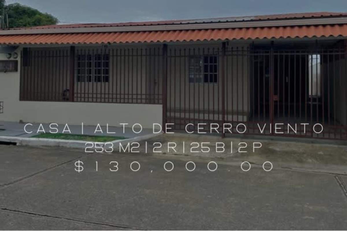 Living room with white walls tiled floor pendant lights in Cerro Viento house Panama City
