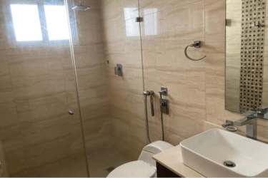 Modern bathroom with glass enclosure, vessel sink and tile walls at Senderos Costa Verde La Chorrera Panama