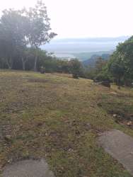 Concrete paved road with grass embankments in rural mountain setting Chicá Campana Panama