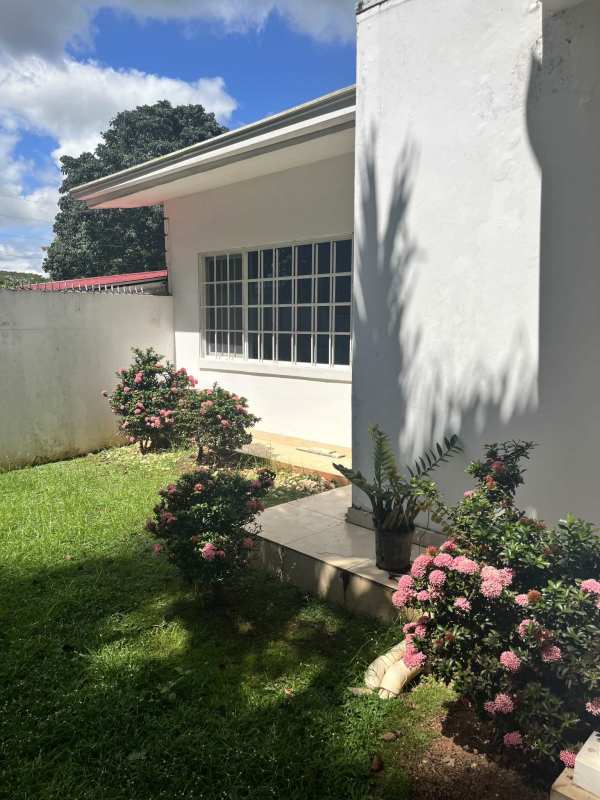 Bedroom with large window overlooking garden and natural light Panama City