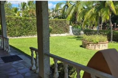 Large garden with lawn, palm trees and tropical plants in beach house for sale Coronado Panama