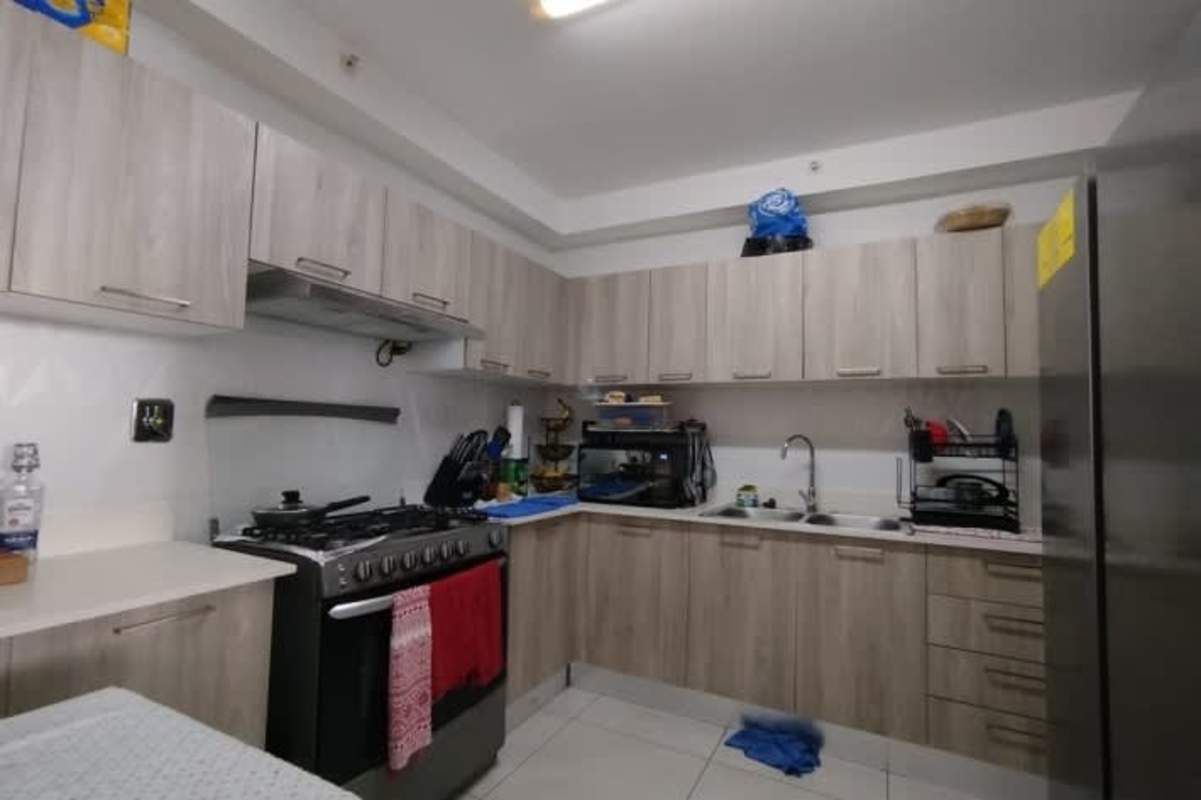 Minimalist bedroom with large window city skyline view Vivendi Green Edison Park Panama