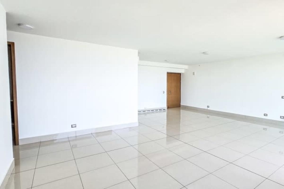 Bright modern living room with balcony access and skyline views in PH Bali Costa del Este Panama apartment