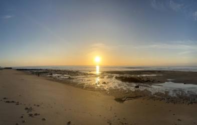 Covered patio with mango fruit bowl, glass table, garden view in Las Lajas Chame Panama