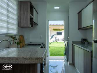 Kitchen area in new house with modern cabinetry and stone counter in Residencial Los Villas 2 La Villa Panama