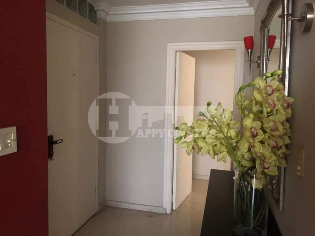 Contemporary dining area with dark wood table, mirror wall, modern lighting in PH Marsella apartment Marbella Panama