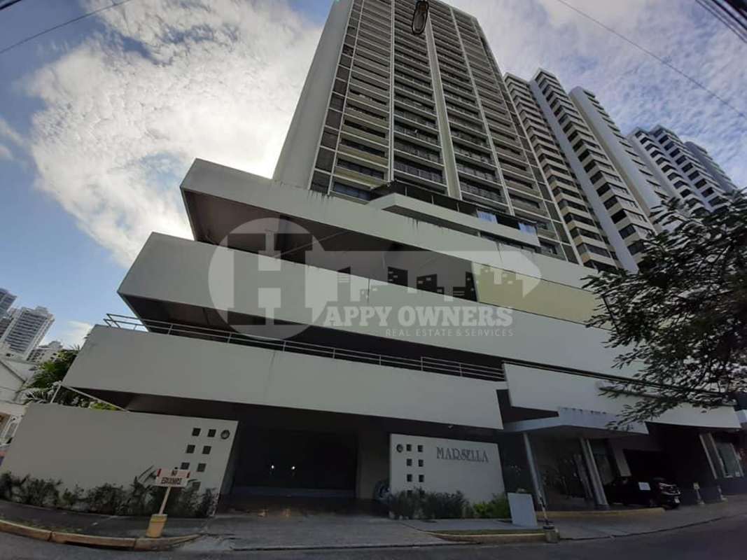 Modern living room with black sofas, large windows city view PH Marsella apartment Marbella Panama