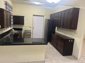 Kitchen with appliances and window in unfurnished Howard rental house Panama