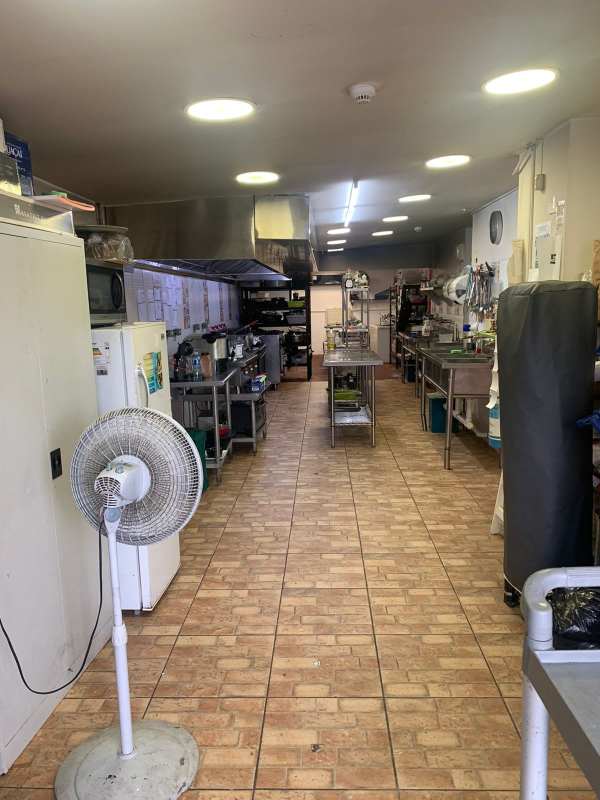 Commercial kitchen area with stainless steel tables sinks and shelving in Panama