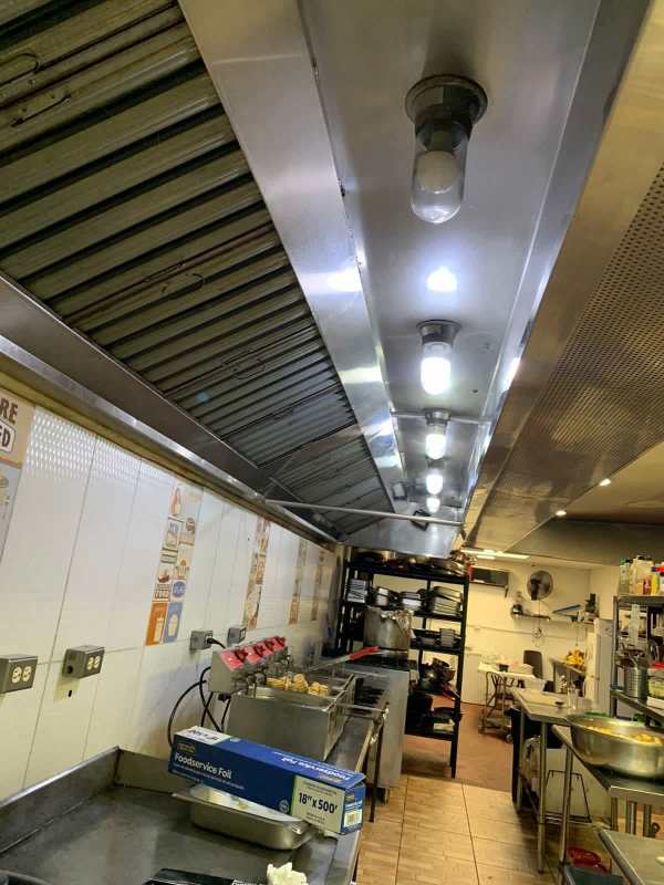 Modern office area with glass sliding door and wood-accent walls El Dorado