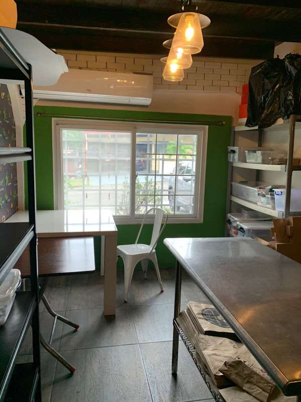 Bright workspace utility room with large windows and metal shelving in Panama