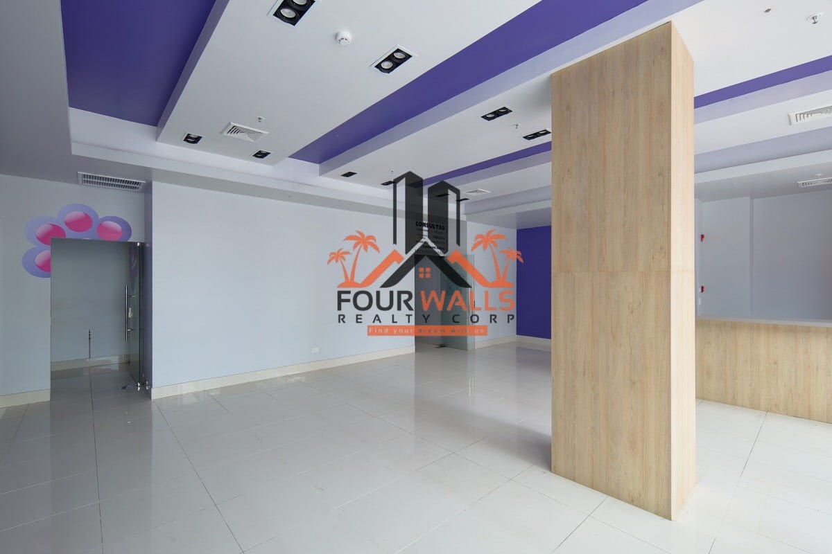 Lobby with glass doors, reception counter, wood accents in Balboa Boutiques commercial mall Panama City