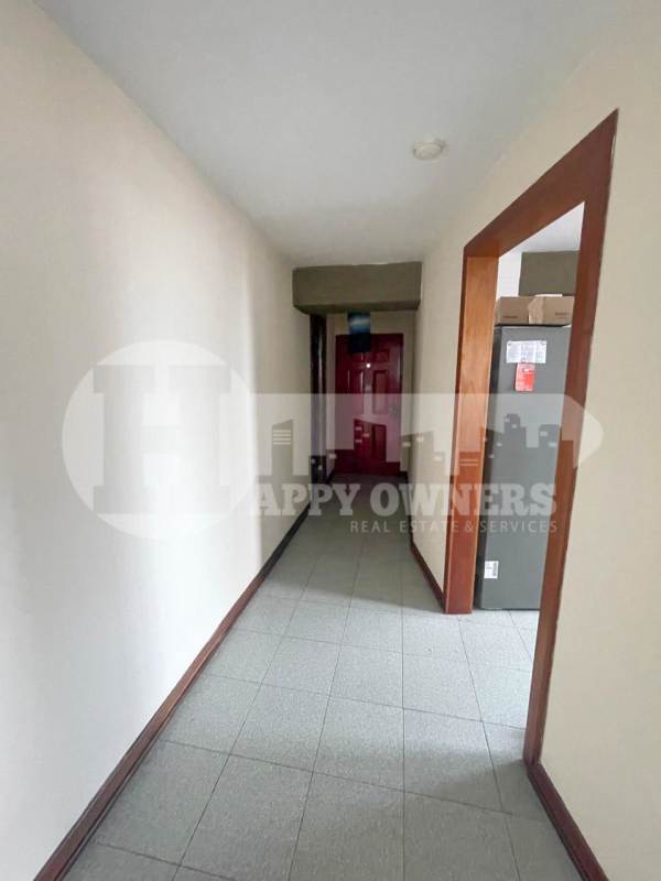 Bright living room with tiled floor, large window and neutral tones in PH Faro del Sur San Francisco Panama
