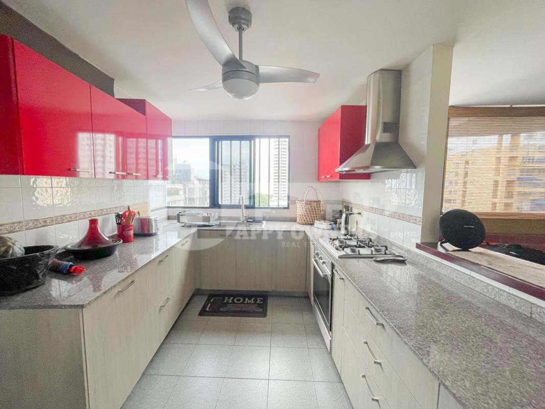 Large bedroom with tiled floors, closet and city view window in PH Faro del Sur Panama