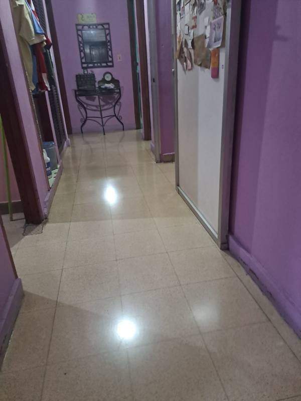 Interior hallway with purple wall, tiled floor, closet and decor Villa de las Fuentes Panama