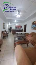 Living room with sliding glass door to balcony and mountain views at PH Boquete Gardens Panama