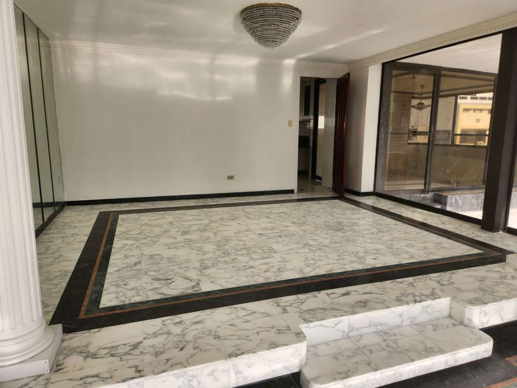 Additional living space with marble flooring and large windows in PH Paitilla Penthouse Panama City