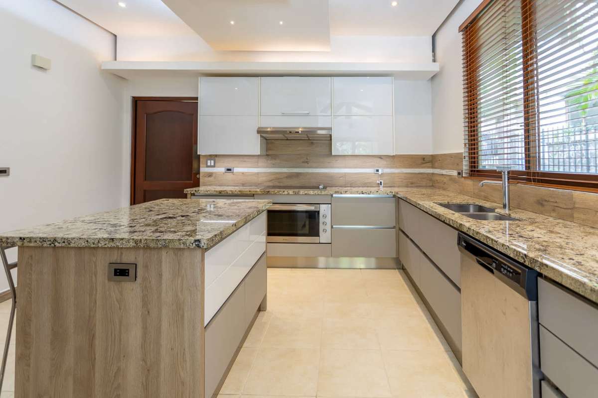 Renovated kitchen with granite countertops, island, stainless appliances in Camino de Cruces El Dorado house