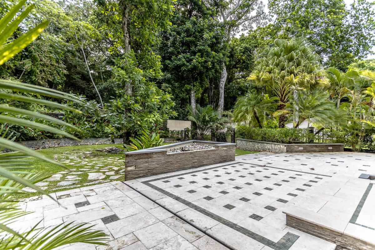 Beautifully landscaped backyard with raised planters, mature trees Camino de Cruces Panama property