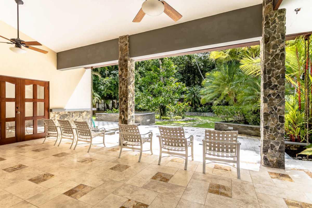 Mediterranean covered terrace with stone columns, ceiling fans, garden Camino de Cruces Panama