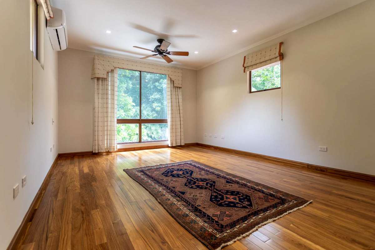 Living room with wood floor, ceiling fan, garden views Camino de Cruces Mansion Panama