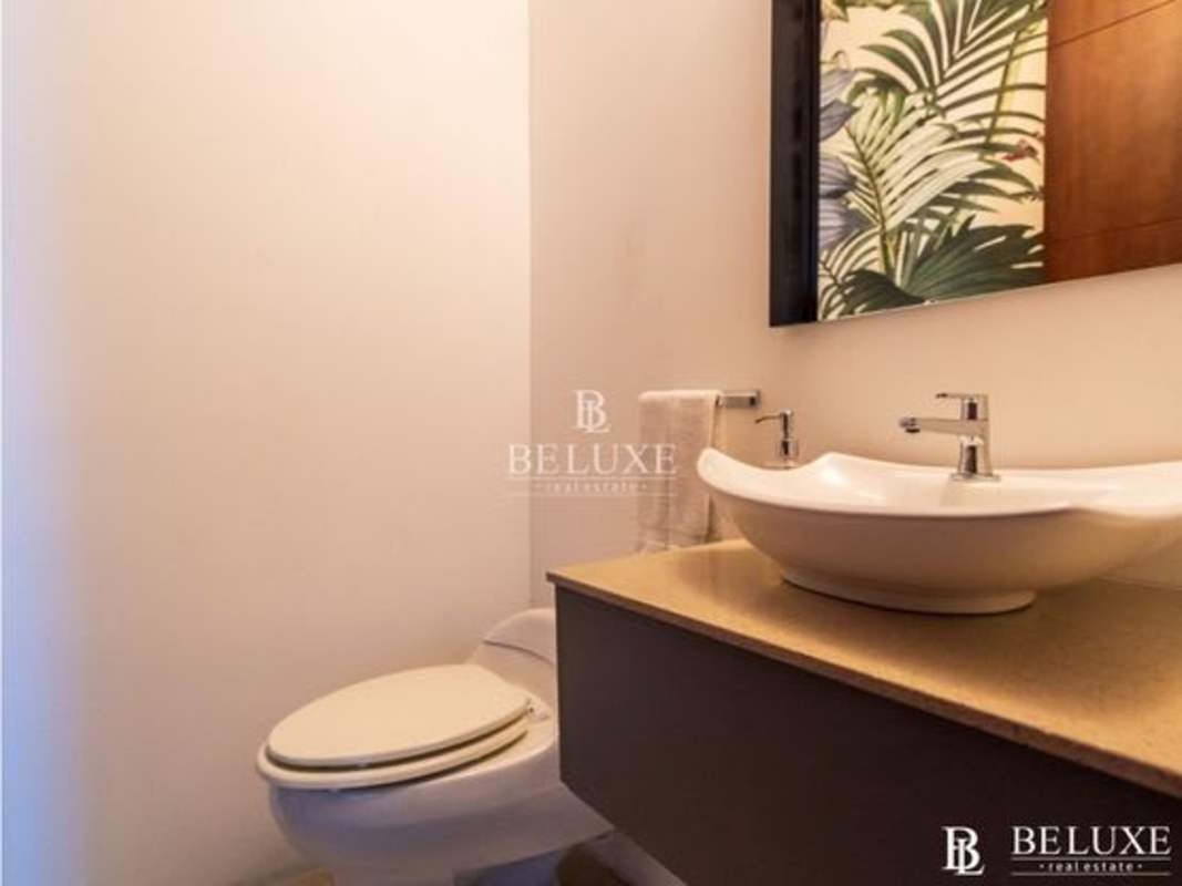 Half bathroom with vessel sink and decorative mirror PH Elevation Costa del Este Panama