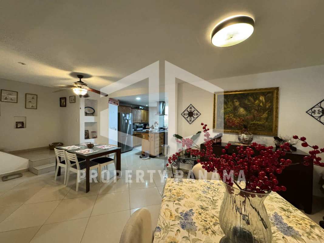 Dining space with ceiling fan tile floor and kitchen in Panama house for sale